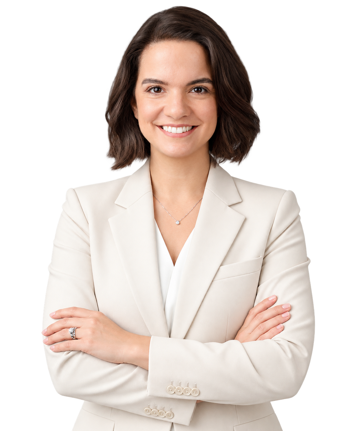 Woman in a cream-colored suit with arms crossed, smiling, standing against a plain white background.